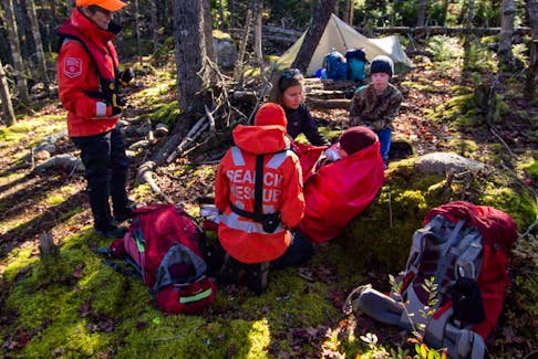 Halifax Search and Rescue team members tend to a patient during a training exercise. Frequent field training keeps members ready to respond.
