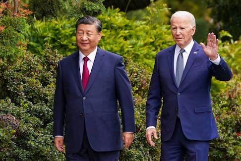 U.S. President Joe Biden waves as he walks with Chinese President Xi Jinping at Filoli estate on the sidelines of the Asia-Pacific Economic Cooperation (APEC) summit, in Woodside, California, U.S., November 15, 2023.