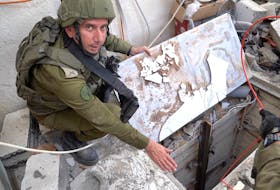 Israeli military spokesperson Rear Admiral Daniel Hagari shows what the Israeli military says is a tunnel at a location given as Gaza, in this still image taken from video released Nov. 13. Israel Defense Forces/Handout via REUTERS/File Photo
