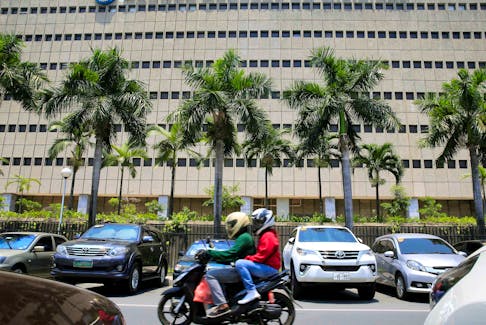 A motorcycle pases a building of the Bangko Sentral ng Pilipinas (Central Bank of the Philippines) in Manila, Philippines April 28, 2016.