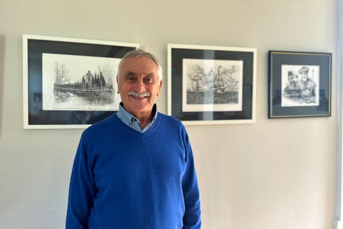 John Ashton with his work that is being displayed at the Bridgeville Community Centre until December. The community centre features just a few different pieces Ashton has completed in his time as a Freelance Grapic Designer. -Sarah Jordan