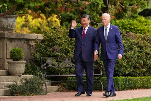U.S. President Joe Biden walks with Chinese President Xi Jinping at Filoli estate on the sidelines of the Asia-Pacific Economic Cooperation (APEC) summit, in Woodside, California, U.S., November 15, 2023.