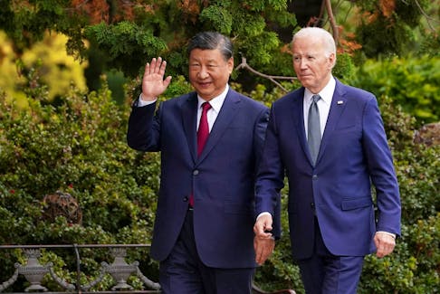Chinese President Xi Jinping waves as he walks with U.S. President Joe Biden at Filoli estate on the sidelines of the Asia-Pacific Economic Cooperation (APEC) summit, in Woodside, California, U.S., November 15, 2023.