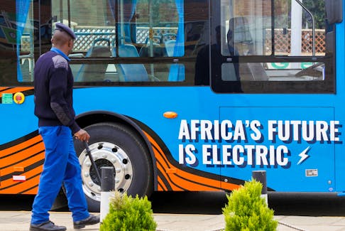 A police officer walks next to an electric mass transit bus assembled by electric vehicle manufacturer Roam at the Green Park Terminus in Nairobi, Kenya October 19, 2022.
