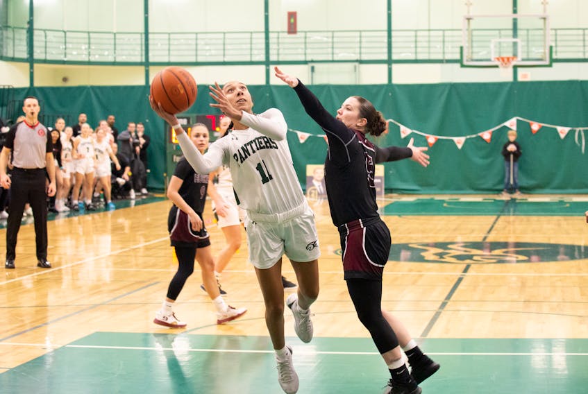Lauren Rainford, 11, of the UPEI Panthers drives to the basket against the Saint Mary’s Huskies in an Atlantic University Sport Women’s Basketball Conference game at the Chi-Wan Young Sports Centre in Charlottetown on Nov. 17. Rainford scored the game’s winning basket on the play with six seconds remaining as the Panthers rallied to defeat the Huskies 64-62. Janessa Vanden Broek, UPEI Athletics • Special to The Guardian