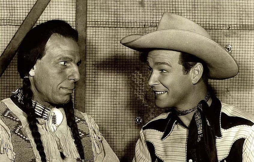 Iron Eyes Cody (left) and Roy Rogers in “North of the Great Divide.” - Publicity still