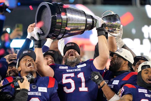 Montreal Alouettes linebacker Avery Williams (2), offensive lineman Kristian Matte (51) and linebacker Darnell Sankey (1) celebrate with the Grey Cup after defeating the Winnipeg Blue Bombers in the 110th Grey Cup at Tim Hortons Field in Hamilton, Ont., Sunday, Nov. 19, 2023. - John E. Sokolowski / USA TODAY Sports