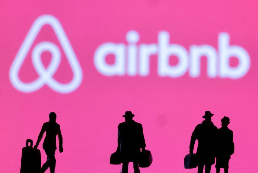 Figurines are seen in front of the Airbnb logo in this illustration taken February 27, 2022.