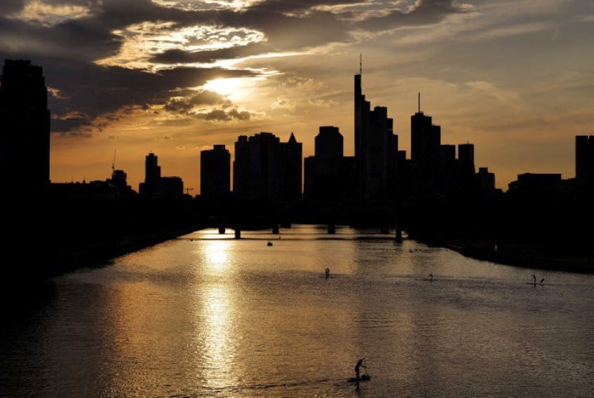 The sun sets behind the skyline of Frankfurt, Germany, August 30, 2022. 