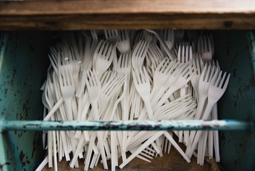 A drawer of disposable plastic forks.