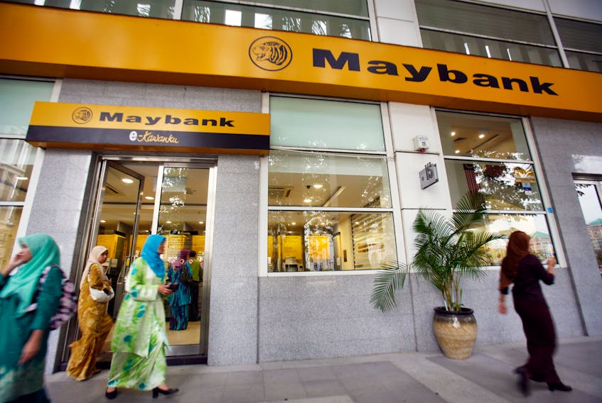 Customers leave a branch of Malaysia's Maybank in Putrajaya October 9, 2009.