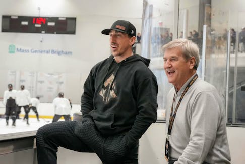 Boston Bruins captain Brad Marchand, left, shares a moment with NHL legend Bobby Orr on Saturday. - Boston Bruins