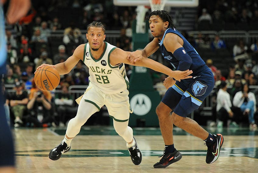 Milwaukee Bucks guard Lindell Wigginton (28) dribbles past Memphis Grizzlies guard Kennedy Chandler (1) in the second half of an NBA pre-season game in Milwaukee on Oct. 1. - Michael McLoone-USA TODAY Sports