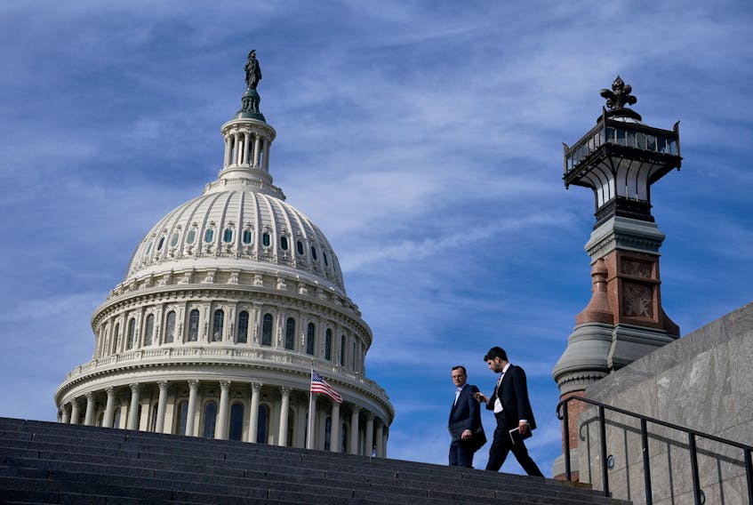 People walk past the U.S. Capitol building in Washington, U.S., November 15, 2023.