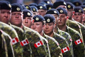 Members of the Canadian Armed Forces march during the Calgary Stampede parade in Calgary, Friday, July 8, 2016.