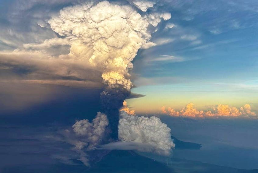 Ash column rises from Mount Ulawun, as seen from an aeroplane window, Papua New Guinea November 21, 2023, in this picture obtained from social media. Enoch Lapa/via REUTERS