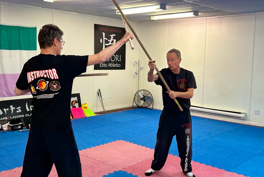 Mount Pearl native and martial arts teacher John Maidment (right) instructs a series of Thai weapon art Krabi Krabong during a session in his hometown on Nov. 20. Maidment, who has learned under famed martial artists Dan Inosanto while living in California, was in town for a visit and ran a series of seminars. Here, Maidment is working alongside Sifu Dennis White. Nicholas Mercer/The Telegram