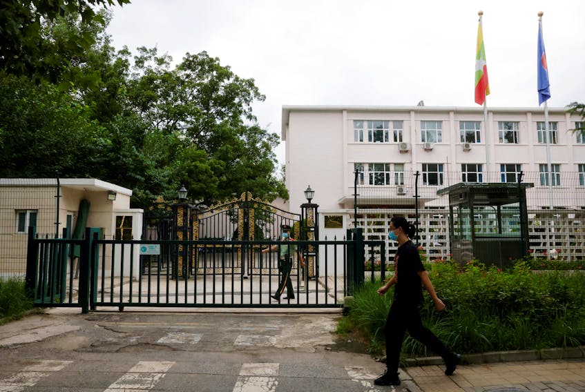 A man walks past a paramilitary police officer keeping watch outside the Myanmar embassy in Beijing, China August 8, 2022.