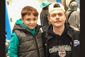 Summerside D. Alex MacDonald Ford Western Capitals forward Reid Vos, right, poses with one of his biggest fans, Chris Hurlburt, following a Maritime Junior Hockey League (MHL) game in Yarmouth, N.S., earlier this season. Vos and Chris developed a friendship last spring when Vos played for the Yarmouth Mariners. - Allison Hurlburt Photo/Special to SaltWire