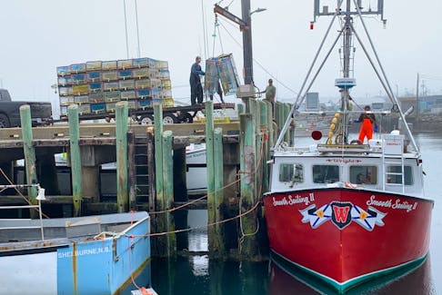 Lobster traps are offloaded from the Smooth Sailing II at then West Head wharf on Cape Sable Island as the lobster fishery in southwestern Nova Scotia was coming to a close last spring. KATHY JOHNSON