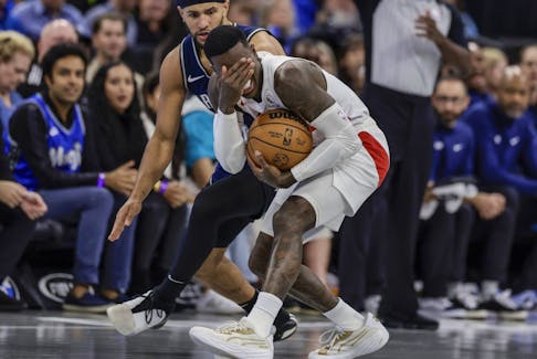 Toronto Raptors guard Dennis Schroder, right, reacts after being fouled by Orlando Magic guard Jalen Suggs during the first half of an NBA basketball In-Season Tournament game Tuesday, Nov. 21, 2023, in Orlando, Fla. (AP Photo/Kevin Kolczynski)