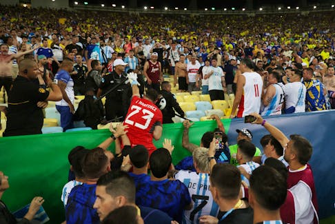 Soccer Football - World Cup - South American Qualifiers - Brazil v Argentina - Estadio Maracana, Rio de Janeiro, Brazil - November 21, 2023 Argentina's Emiliano Martinez and teammates react as fans clash with security staff in the stands causing a delay to the start of the match