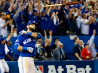Jose Bautista of the Toronto Blue Jays hits a three-run homer against the Texas Rangers in Game 5 of the American League Division Series in Toronto on Wednesday, October 14, 2015. 