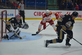 Charlottetown Islanders defenceman Owen Conrad, 10, attempts to block a shot in the first period of a Quebec Major Junior Hockey League (QMJHL) game against the Baie-Comeau Drakkar at Eastlink Centre on Nov. 22. Islanders goaltender Carter Bickle, 1, and Drakkar forward Félix Gagnon, 22, track the puck. Gagnon recorded four points to lead the Drakkar to a 5-3 win. Jason Simmonds • The Guardian