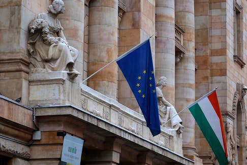The Hungarian national flag and the flag of the European Union fly on the building of the National Bank of Hungary in Budapest January 10, 2013.