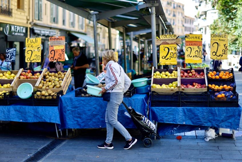 A woman shops at a local market in Nice, France, April 26, 2023.