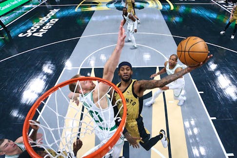 Jalen McDaniels (2) of the Toronto Raptors drives to the net around Sam Hauser (30) of the Boston Celtics during their NBA In-Season Tournament game at Scotiabank Arena on November 17, 2023 in Toronto (Cole Burston/Getty Images)