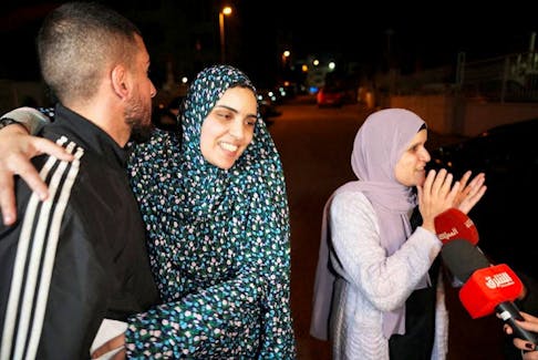 Released Palestinian prisoner Marah Bkeer reacts with a family near her house after hostages-prisoners swap deal between Hamas and Israel, in Jerusalem November 24, 2023.