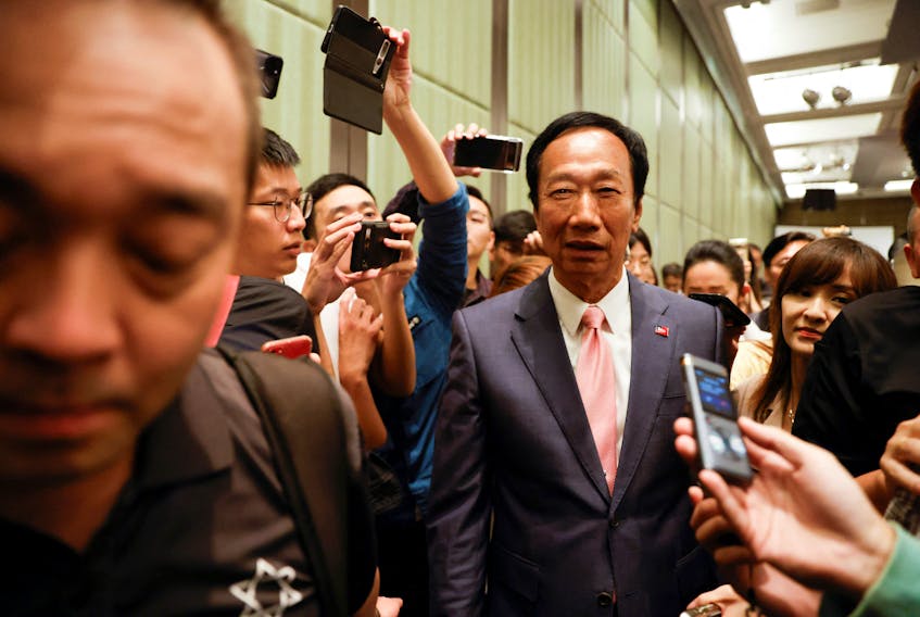 Terry Gou, Foxconn founder and presidential candidate, walks among media members during a press conference in Taipei, Taiwan November 23, 2023.