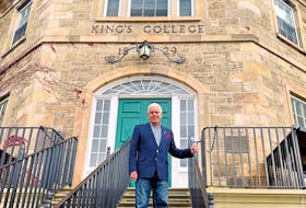University of New Brunswick economics professor Constantine Passaris says teaching is something he enjoys doing and is the reason why he is still doing it after 50 years on the job. He is shown at the historic Old Arts Building on the UNB campus. - Michael Staples/New Canadian Media