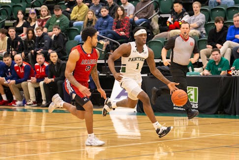 The UPEI Panthers’ Kamari Scott, 1, dribbles the ball up the court while the Acadia Axemen’s Demeric Mercer, 3, defends. The action took place during an Atlantic University Sport (AUS) Men’s Basketball Conference game at the Chi-Wan Young Sports Centre in Charlottetown on Nov. 25. UPEI won the game 76-60. Janessa Vanden Broek/UPEI Athletics • Special to The Guardian