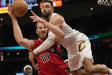 Toronto Raptors centre Jakob Poeltl is fouled by Cleveland Cavaliers guard Max Strus.