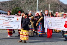 Eskasoni residents marched on Sunday from the community health centre's healing garden to Allison Bernard Memorial High School wearing red toques and holding signs featuring the faces of Indigenous women and men who never came home, to raise awareness about Missing and Murdered Indigenous People. The walk was followed by speeches and performances during a reception at the school's gymnasium. MITCHELL FERGUSON/CAPE BRETON POST