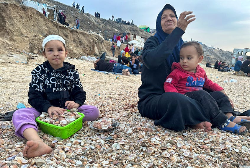 Palestinians spend time on a beach during a temporary truce between Hamas and Israel, in Deir al-Balah in the central Gaza Strip November 25, 2023.