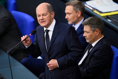 Chancellor Olaf Scholz speaks next to Finance Minister Christian Lindner and Economy and Climate Minister Robert Habeck during a hearing at Germany’s lower house of parliament Bundestag in Berlin, Germany, November 15, 2023.
