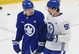 Toronto Maple Leafs John Tavares (left) and  Mitch Marner chat on the ice before practice.