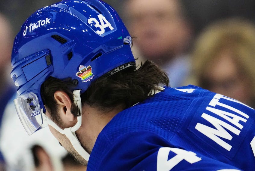 Toronto Maple Leafs' Auston Matthews (34) wears a pride-themed sticker on his helmet.