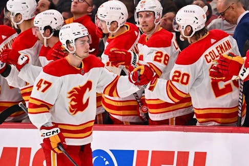 Connor Zary of the Calgary Flames celebrates a goal with teammates against the Montreal Canadiens at the Bell Centre on November 14, 2023.