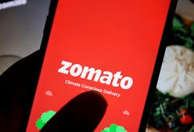 The logo of Indian food delivery company Zomato is seen on its app on a mobile phone displayed in front of its company website in this illustration picture taken July 14, 2021.