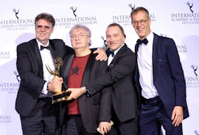 Producers Michel Feller, Dominique Besnehard, and Harold Valentin pose backstage after winning an Emmy for "Call My Agent!" in the category Comedy at the 49th International Emmy Awards in New York City, New York, U.S., November 22, 2021.