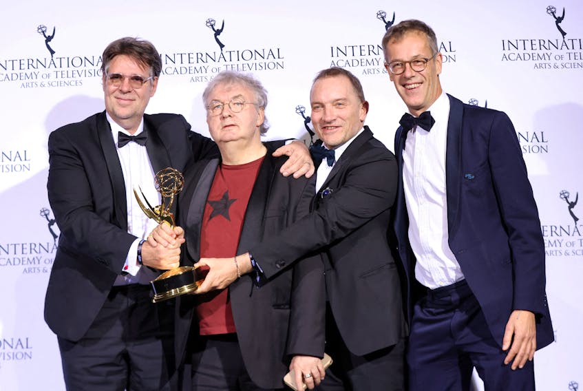 Producers Michel Feller, Dominique Besnehard, and Harold Valentin pose backstage after winning an Emmy for "Call My Agent!" in the category Comedy at the 49th International Emmy Awards in New York City, New York, U.S., November 22, 2021.
