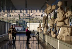 People visit the Parthenon Gallery, designed to accommodate the sculptures of the Parthenon, at the Acropolis Museum in Athens, Greece, November 27, 2023.