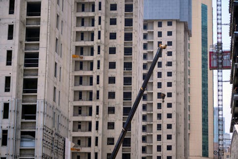 A crane is seen amid residential buildings under construction in Shanghai, China July 20, 2022.