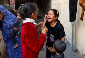 Palestinian children react after an Israeli strike on a house, amid the ongoing conflict between Israel and Palestinian Islamist group Hamas, in Khan Younis in the southern Gaza Strip November 18, 2023.