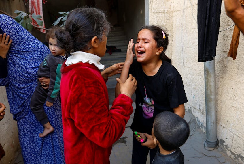 Palestinian children react after an Israeli strike on a house, amid the ongoing conflict between Israel and Palestinian Islamist group Hamas, in Khan Younis in the southern Gaza Strip November 18, 2023.
