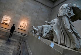 An employee views examples of the Parthenon sculptures, sometimes referred to in the UK as the Elgin Marbles, on display at the British Museum in London, Britain, January 25, 2023.
